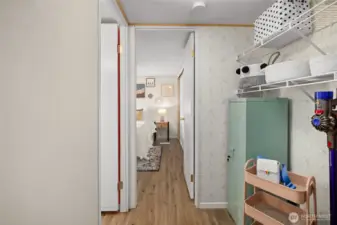 hallway leading to bedrooms with washer hook up on the right