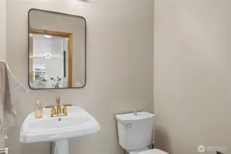 Hall bath with updated fixtures and mirror.