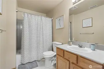 Hall bath with full tub shower surround.