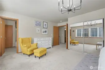Primary bedroom suite with double mirrored closets on one side.