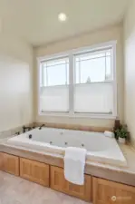 Relax with a bubble bath in your roomy soaker tub with tile surround, upgraded faucet & pretty windows