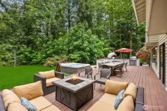 Massive deck with outdoor dining and living overlooking completely private and level backyard.