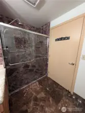 Double shower heads with marble tile.