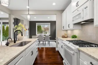Kitchen leads into the light filled dining room.