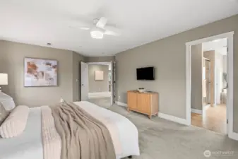 3rd view of primary suite looking toward the ensuite bath and the french doors that lead out to the hallway.