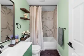 Full bathroom located downstairs with high ceilings