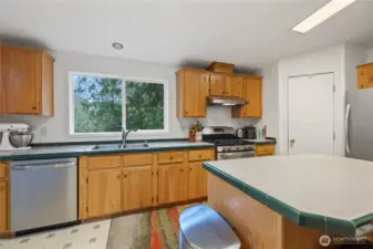 Propane oven/range, dishwasher, and lovely view outside the kitchen window