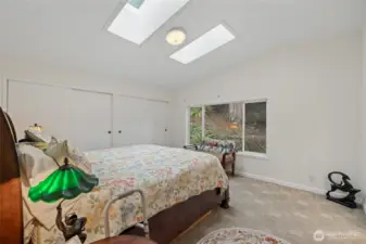 Primary bedroom with double closets and skylights