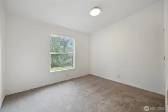 Bedroom 2 without virtual staging. New carpet and paint