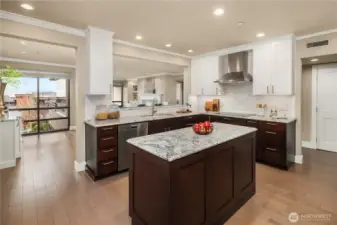 The chef-inspired kitchen is designed to impress, featuring premium Miele appliances, Sub-Zero refrigeration for both food and wine, sleek slab granite surfaces, and bar seating that invites connection.