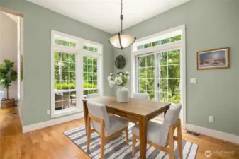 The bright dining area overlooks the forested back yard.