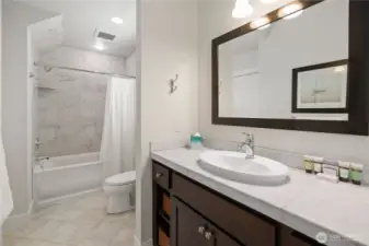 Primary bathroom with stack laundry