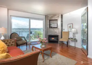 Living room with gas fireplace and lake view.