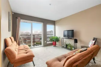 Spacious living room with oversized windows offers natural light and mountain & city views.