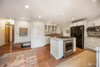 If you look carefully you can see that the floor plan is circular on the main level, which is a nice touch that adds visual interest. The door on the left leads to a half bath and laundry room, and the garage door is just right of the bath. The 6-panel solid fir doors throughout the house are really an upgrade.