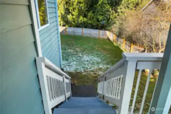 The stairs off the deck offer easy access to the fully fenced, predominantly level yard.