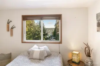 Bedroom 2 offers a partial sunrise view, showcasing the water and mountains to the east.