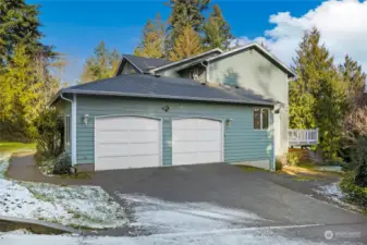 I like the double garage with shop space, and there's plenty of room for two full-size vehicles. With the additional gravel parking off to the right, there's more than enough parking.