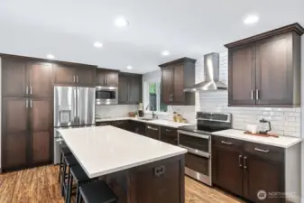 Large kitchen island with bar seating and extra cabinets