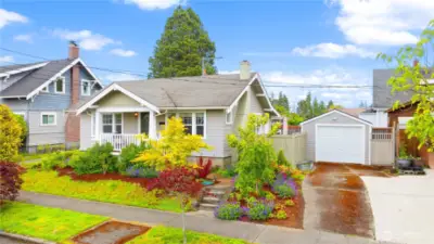 Lush landscaping with a sprinkler system. 3 spots for parking (1 in garage, 2 spots in long driveway)
