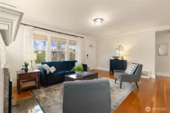 Large windows and restored hardwood floors - what an inviting living room!