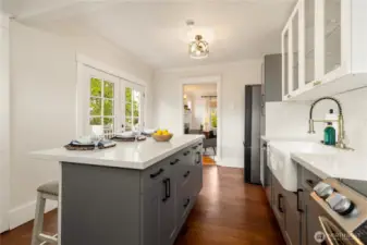 Plenty of cabinets - what a great kitchen to cook delicious meals! Two places to eat: the island or through the French doors on the deck!
