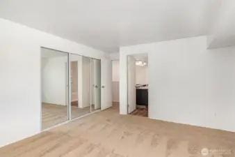 Primary bedroom also features a spacious closet with elegant mirrored doors, enhancing light and style.