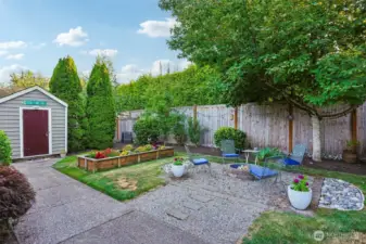 Fully fenced backyard also includes a garden/tool shed.