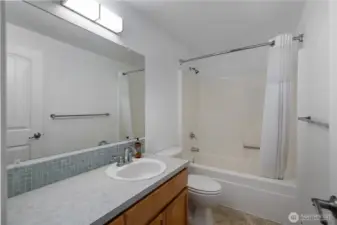 Guest bathroom is easily accessible off living space and off guest bedrooms in hallway. Large vanity and full sized shower make this space very usable.