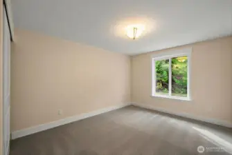 View of bedroom number two at end of hallway. Great sized room with plenty of closet space and natural light. New carpeting and fresh paint!