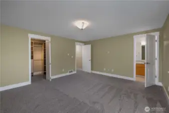 Alternate view of primary suite, notice the walk in closet to the left and primary en suite bathroom directly ahead toward the right. Fantastic sized room. New carpeting and fresh paint.