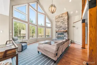 Floor to ceiling windows and stone fireplace. A beautiful space!