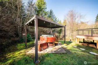 Hot tub just off the deck with a pergola cover.