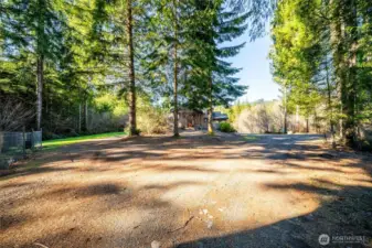 Large circular drive with plenty of parking. Fenced in dog run to left.