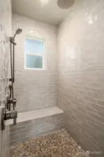 Large shower with waterfall showerhead.