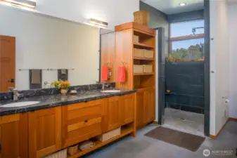 Primary bath has limestone with fossil counters, cherry cabinets and slate shower.