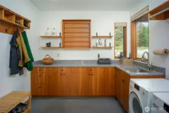 Laundry room has the coolest drying rack you have ever seen.