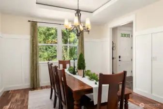 Elegant touches include wainscoting & a tray ceiling.