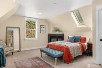 The 4th bedroom offers its own fireplace along with a bright skylight.