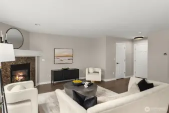 The half-bath lies behind the closed door by the foyer.