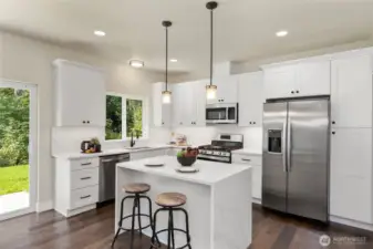 This island features striking waterfall edges, abundance of counter space and still room for casual dining.  Sliding door to back yard.