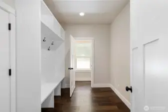 Spacious drop zone off the garage entrance and looking towards the half bathroom.