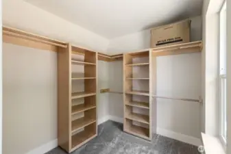 Primary suite walk-in closet is complete with built in storage space.