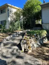 Concrete stairs to front yard.