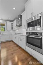 Quartz Countertops, Stainless Steel Appliances, Soft-Close Cabinetry and Drawers, Topped Off with Marble Subway Tiles and Elegant Crown Molding.