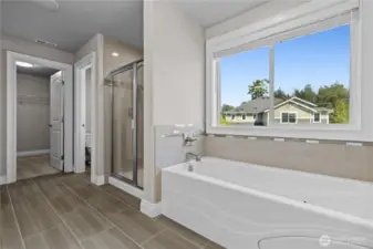 Primary Bathroom with Jetted Tub, Shower and Private Water Closet.