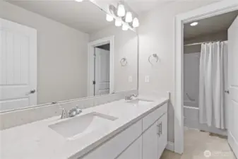 Upper-Level Guest Bathroom with Dual Vanity, Separate Shower and Water Closet. Upgraded Quartz Countertops and Tile Flooring.