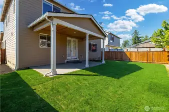 Back Covered Patio with Gas BBQ Stub for Convenient Grilling and a Fresh New Lawn.