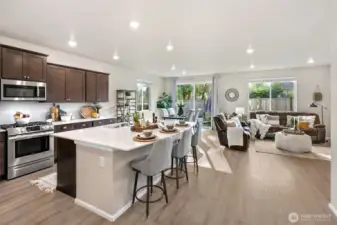 Open concept kitchen and living with oversized quartz island