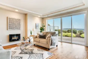 A serene sanctuary with sweeping views, this living room pairs architectural grace with quiet luxury—anchored by a gas fireplace and framed by the Puget Sound.